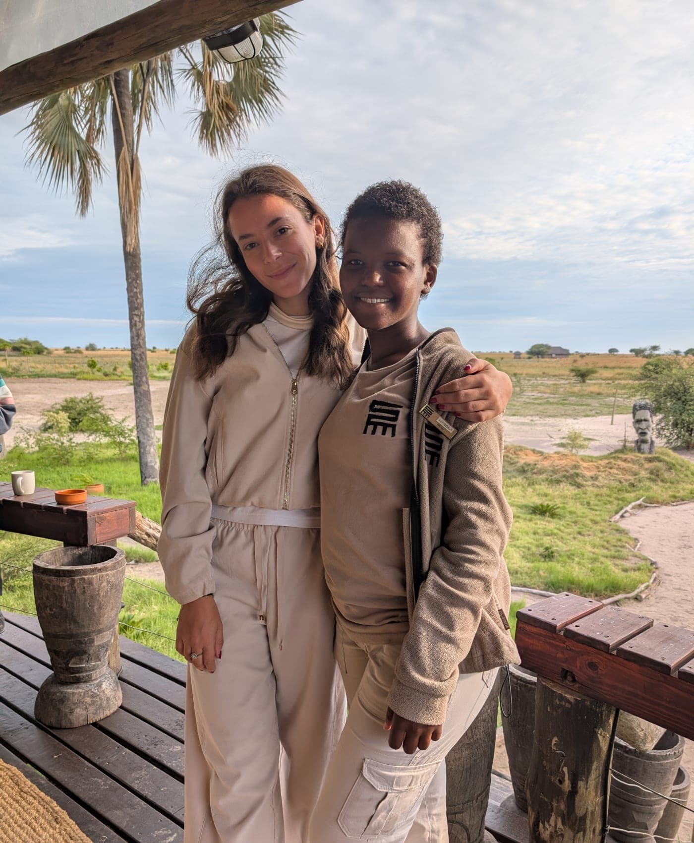 A young guest and a child from a neighboring village on the camp deck
