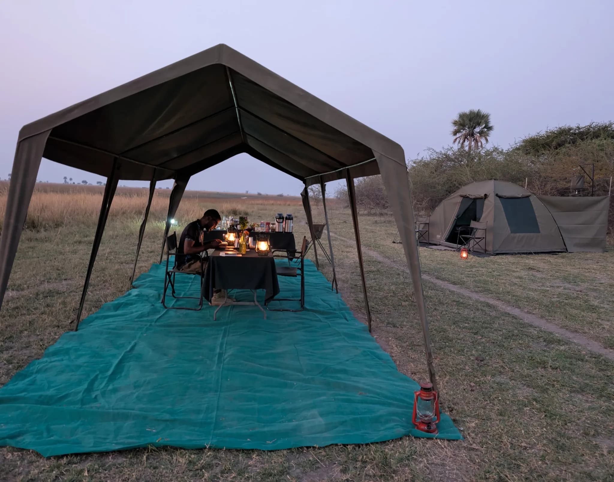 Dinner under the dining tent at the mobile camp, at dusk