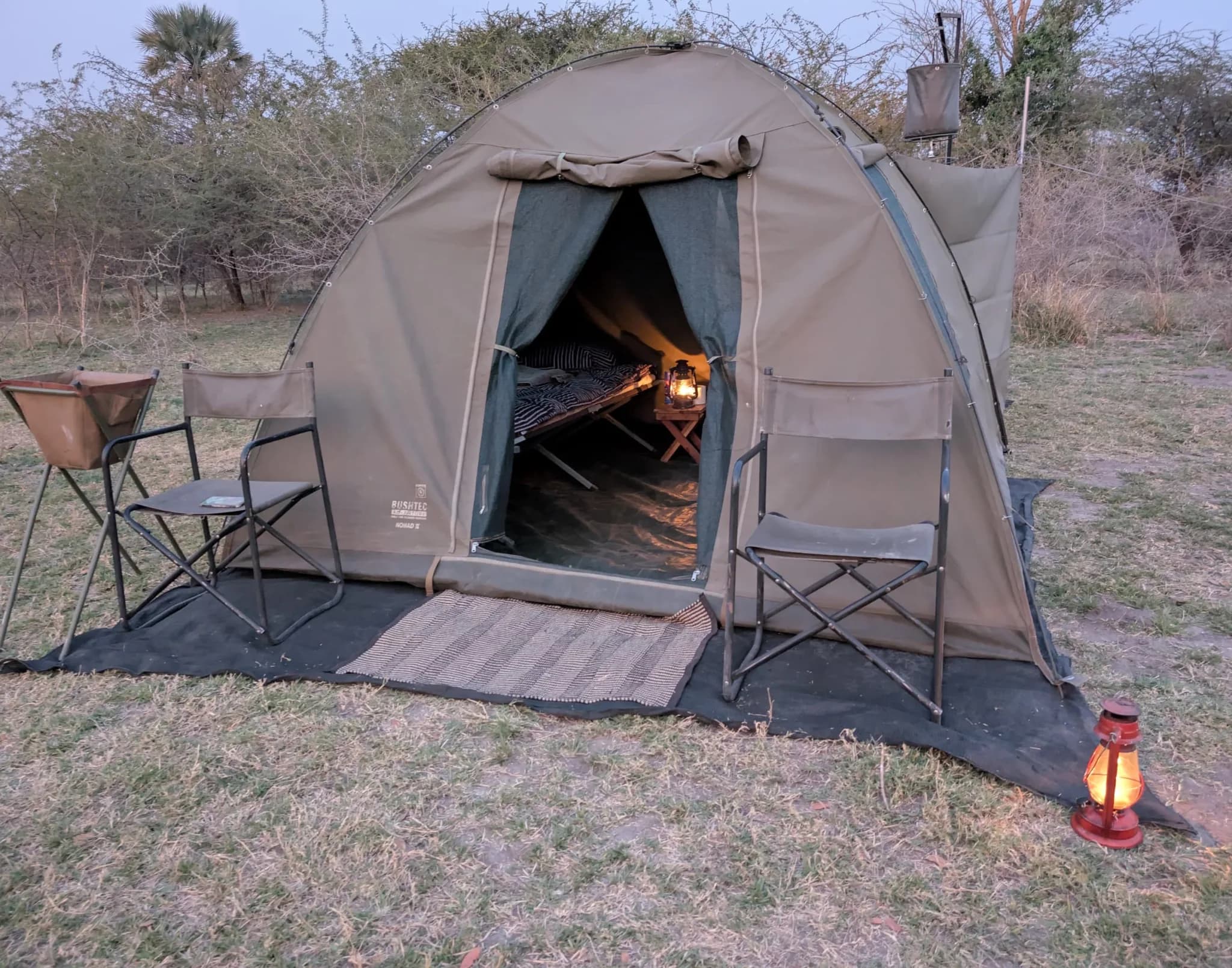 A guest tent at the mobile camp, with its wash basin and shower bucket